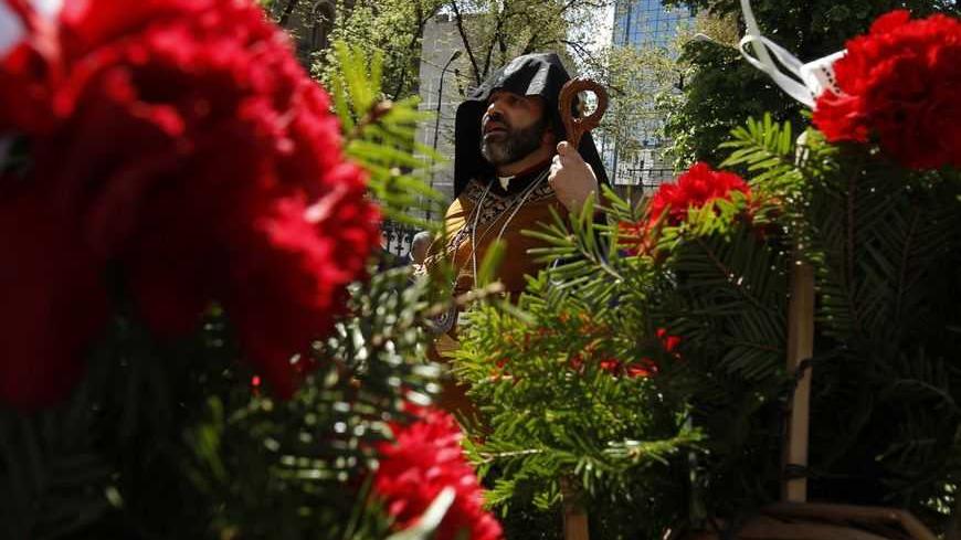 Armenian Bishop Datev Hagopian attends a wreath laying ceremony after a special prayer marking the anniversary of mass killings of Armenians in Ottoman Empire in 1915, outside the Armenian Church in Bucharest April 24, 2012. Armenia, backed by many historians and parliaments, says that about 1.5 million Christian Armenians were killed in what is now eastern Turkey during World War One in a deliberate policy of genocide ordered by the Ottoman government. Successive Turkish governments and the vast majority o