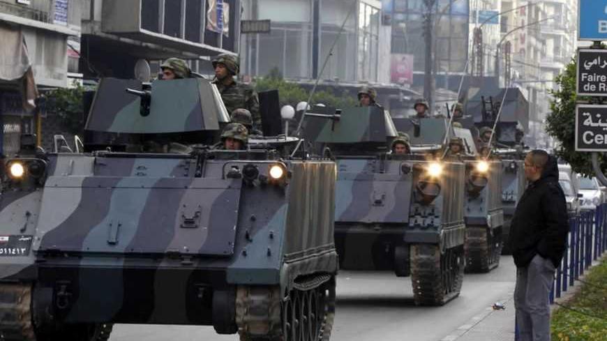 Lebanese Army soldiers deploy after gunmen ambushed the convoy of Lebanese Minister of Sports and Youth Faisal Karami in the northern city of Tripoli January 18, 2013. Gunmen ambushed the convoy in Tripoli on Friday, wounding three people and riddling a security patrol car with bullets, medics and witnesses said. Karami, appeared to be unhurt, the medics said. REUTERS/Mohamed Azakir (LEBANON - Tags: POLITICS CIVIL UNREST) - RTR3CLYJ