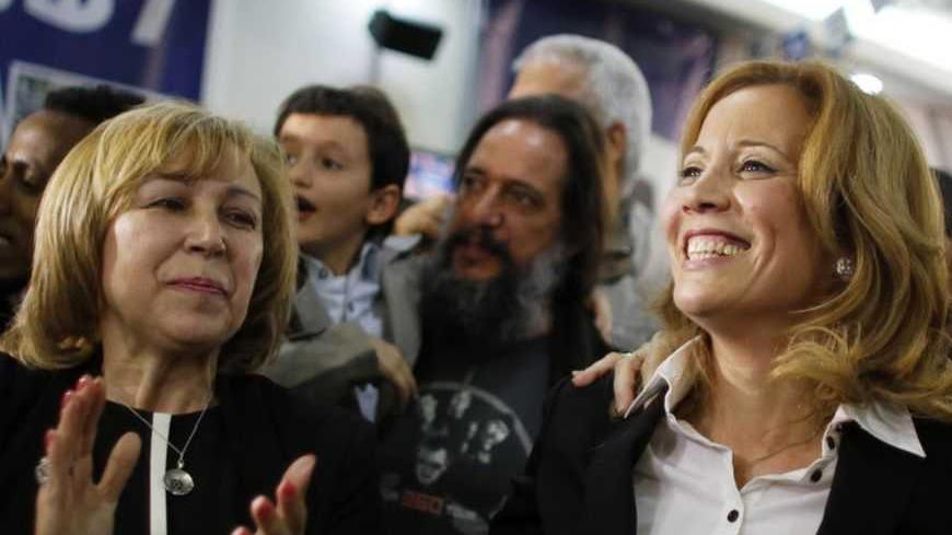 Dr. Aliza Lavie (C), a Yesh Atid (There's a future) party candidate, celebrates exit poll results at the party's headquarters in Tel Aviv January 22, 2013. Israel's parliament, long heavy with retired generals, is getting a new look, with a freshman class that includes two youth protest leaders, an Ethiopian immigrant, a high tech millionaire and more women than ever. Thanks to the surprise second place finish of Yesh Atid, as well as the success of a new far-right group, the 120-member Knesset will have a 