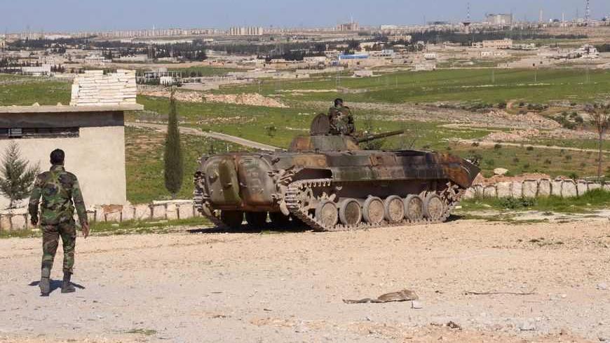 A soldier loyal to Syria's President Bashar al-Assad walks towards an army tank in the Khan al-Assal area, near Aleppo city March 6, 2013. REUTERS/George Ourfalian (SYRIA - Tags: CONFLICT MILITARY POLITICS CIVIL UNREST) - RTR3ENMO
