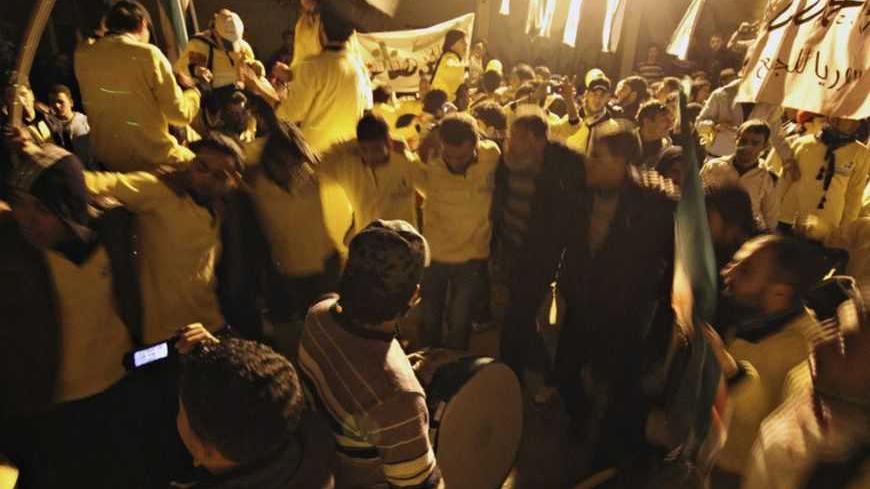 Demonstrators dance during a protest marking two years since the start of the uprising , in the Bustan al-Qasr district in Aleppo March 17, 2013. REUTERS/Giath Taha (SYRIA - Tags: ANNIVERSARY POLITICS CIVIL UNREST) - RTR3F4RR
