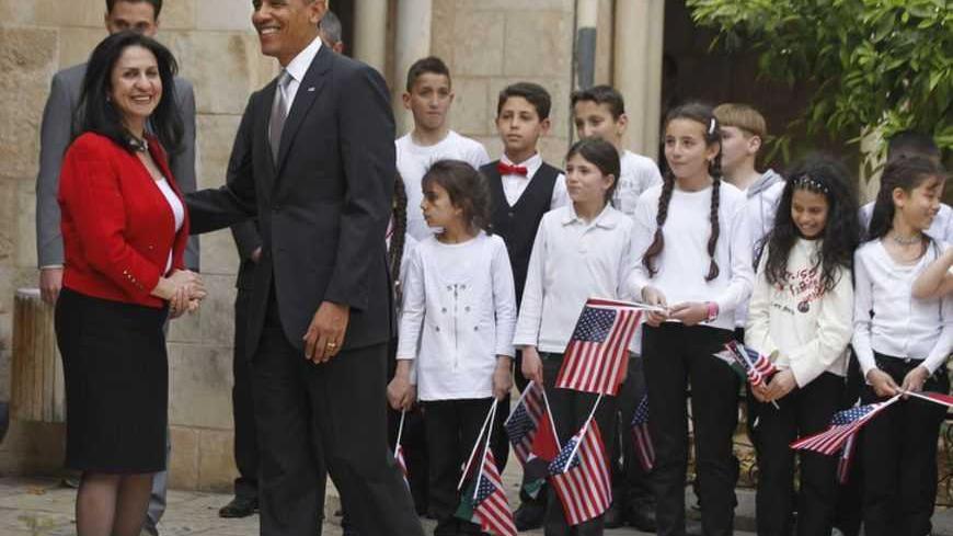 U.S. President Barack Obama is seen next to Bethlehem Mayor Vera Baboun (L) and children at the Church of the Nativity in Bethlehem March 22, 2013. REUTERS/Jason Reed (WEST BANK - Tags: POLITICS RELIGION) - RTR3FBRR