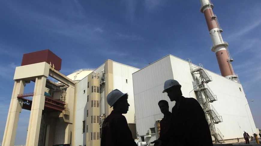 Iranian workers stand in front of the Bushehr nuclear power plant, about 1,200 km (746 miles) south of Tehran October 26, 2010. Iran has begun loading fuel into the core of its first nuclear power plant on Tuesday, one of the last steps to realising its stated goal of becoming a peaceful nuclear power, state-run Press TV reported on Tuesday. REUTERS/Mehr News Agency/Majid Asgaripour (IRAN - Tags: POLITICS ENERGY IMAGES OF THE DAY) - RTXTUI4