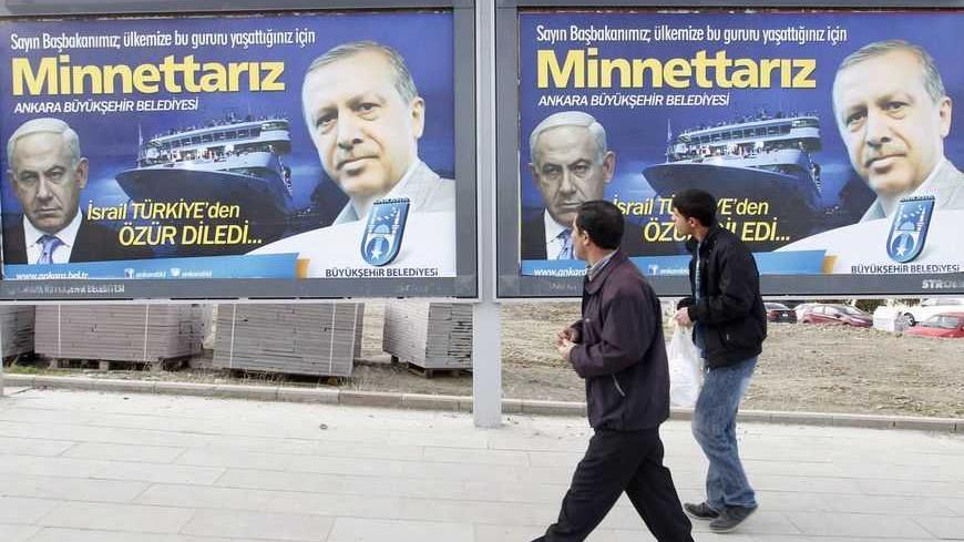 Pedestrians look at billboards with the pictures of Turkey's Prime Minister Tayyip Erdogan (R) and his Israeli counterpart Benjamin Netanyahu (L), in Ankara March 25, 2013. Turkey's Prime Minister Tayyip Erdogan said on Saturday an Israeli apology for the 2010 deaths of nine Turkish pro-Palestinian activists that was brokered by U.S. President Barack Obama met Turkey's conditions and signalled its growing regional clout. The billboard reads, "Israel apologized to Turkey. Dear Prime Minister (Erdogan), We ar