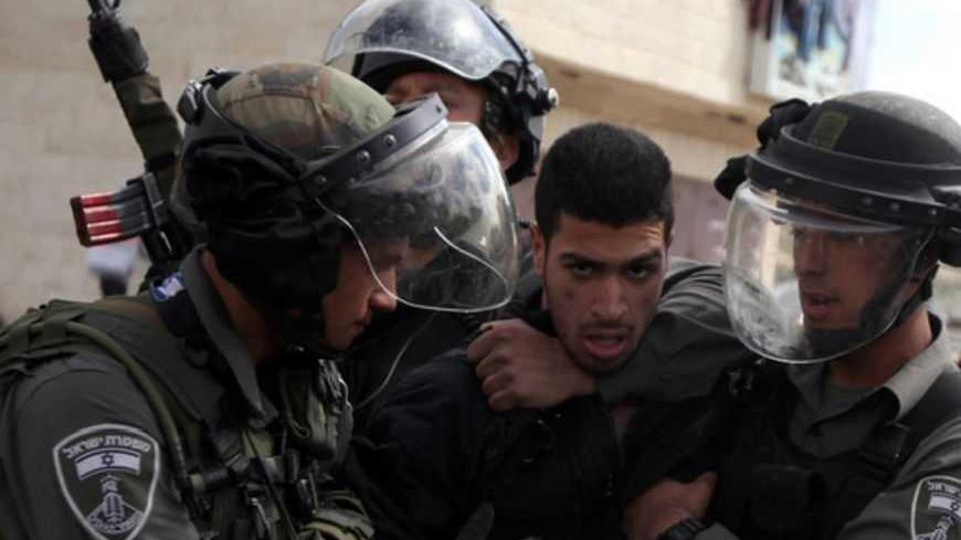 Israeli border guards detain a Palestinian protestors outside Israel's Ofer prison near Ramallah on February 28, 2013 following protests in support of hunger-striking Palestinians in Israeli prisons. Israel's health ministry said the cause of a Palestinian prisoner's death remains unclear following tests on samples from his body, after Palestinian charges he was tortured in detention. AFP PHOTO/ABBAS MOMANI (Photo credit should read ABBAS MOMANI/AFP/Getty Images)
