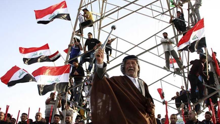 A supporter of Shi'ite cleric Moqtada al-Sadr takes part in a rally, which the participants said was against sectarianism and injustice, in Kut, 150 km (93 miles) southeast of Baghdad, March 16, 2013.    REUTERS/Wissm al-Okili (IRAQ - Tags: CIVIL UNREST TPX IMAGES OF THE DAY) - RTR3F2NB
