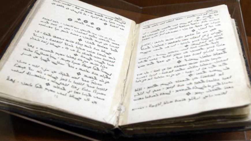 A book written in Aramaic is seen in a glass case at the Museum of St. George's Catholic Church in Kormakitis, Cyprus May 9, 2010. The Aramaic language of the earliest Christians lives on in the church services of the tiny village on the Turkish Cypriot side of the Mediterranean island of Cyprus, where a hybrid dialect of Aramaic is commonly spoken by just 1,000 people who are striving to keep it alive. Picture taken May 9. To match Reuters Life! CYPRUS-LANGUAGE/MARONITES       REUTERS/Andreas Manolis    (C
