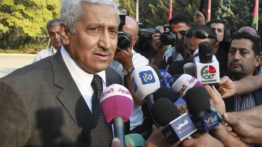 Jordan's new Prime Minister Abdullah Ensour (L) speaks to the media after the swearing-in ceremony for the new cabinet at the Royal Palace in Amman October 11, 2012. King Abdullah swore in a new government on Thursday led by reformist politician Ensour and charged with preparing for Jordan's first post-Arab Spring parliamentary elections. REUTERS/Muhammad Hamed (JORDAN - Tags: POLITICS) - RTR3911T