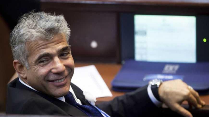 Yair Lapid, head of Yesh Atid (There is a Future) party attends the swearing-in ceremony of the 19th Knesset, the new Israeli parliament, in Jerusalem February 5, 2013. REUTERS/Uriel Sinai/Pool (JERUSALEM - Tags: POLITICS) - RTR3DDXV