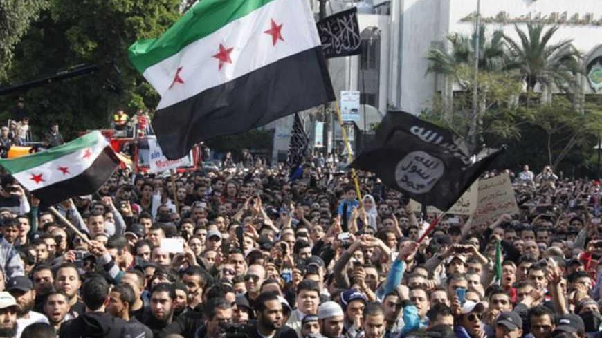 A general view of protesters holding a Syrian opposition flag during a demonstration headed by Sunni Muslim Salafist leader Ahmad al-Assir, in support of residents of the northeastern town of Arsal in Lebanon's Bekaa Valley and Syrian refugees who fled the violence in their country, after Friday prayers in Beirut February 8, 2013. REUTERS/Mohamed Azakir (LEBANON - Tags: POLITICS CIVIL UNREST) - RTR3DHUU