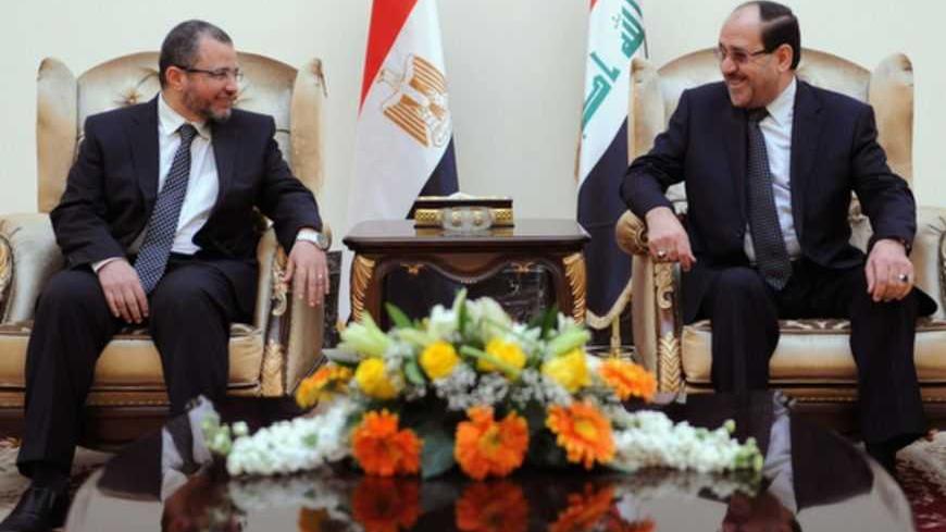Iraq's Prime Minister Nuri al-Maliki (R) speaks with Egypt's Prime Minister Hisham Qandil during his visit to Baghdad, in this March 4, 2013 picture provided by Iraqi Prime Minister Media Office. REUTERS/Iraqi Prime Minister Media Office/Handout (IRAQ - Tags: POLITICS) ATTENTION EDITORS - THIS IMAGE WAS PROVIDED BY A THIRD PARTY. FOR  EDITORIAL USE ONLY. NOT FOR SALE FOR MARKETING OR ADVERTISING CAMPAIGNS.  THIS PICTURE IS DISTRIBUTED EXACTLY AS RECEIVED BY REUTERS, AS A SERVICE TO CLIENTS - RTR3EK1P