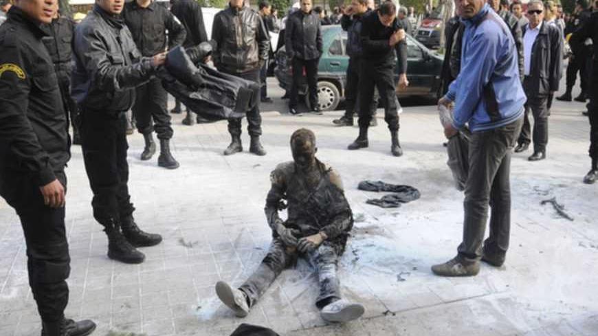 ATTENTION EDITORS - VISUAL COVERAGE OF SCENES OF INJURY AND DEATH

The body of a young Tunisian man, who set himself on fire, is seen at the main street of the capital Tunis March 12, 2013. The man set himself on fire on Tuesday in a gesture recalling the self-immolation of Mohamed Bouazizi, whose death ignited a revolt in Tunisia that echoed across the Arab world. Security forces and bystanders tried to extinguish the flames before the man was rushed to hospital, witnesses said. The reason for his action