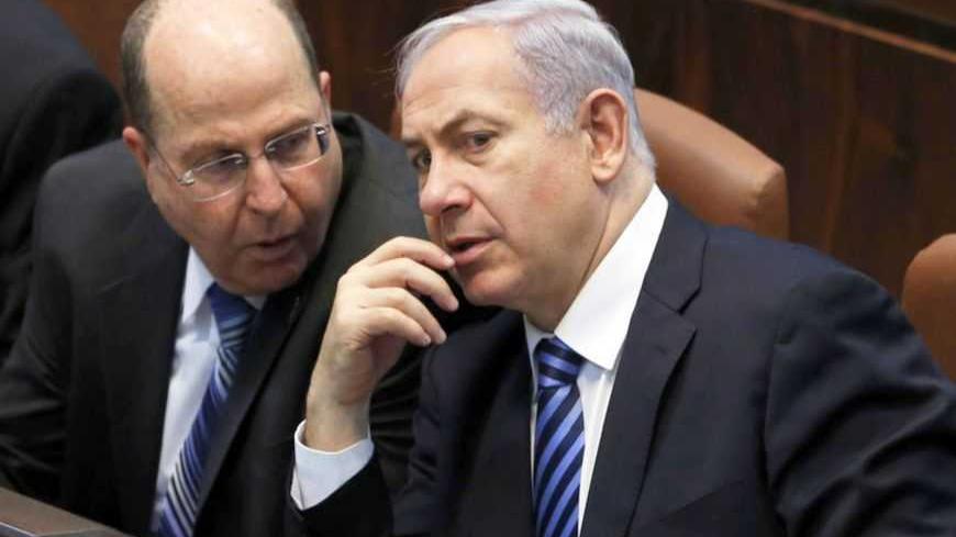 Israel's Prime Minister Benjamin Netanyahu (3rd L) and Defence Minister Moshe Yaalon (2nd L) speak during the swearing-in ceremony, at the Knesset, the Israeli Parliament, in Jerusalem March 18, 2013. Netanyahu's new governing coalition took office after a parliamentary vote on Monday with powerful roles reserved for supporters of settlers in occupied territory. REUTERS/Baz Ratner (JERUSALEM - Tags: POLITICS) - RTR3F5XR