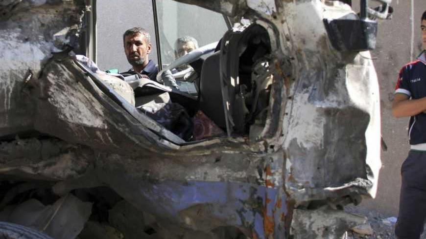 Residents gather at the site of a car bomb attack in Baghdad's Sadr City,March 19, 2013. A dozen car bombs and suicide blasts tore into Shi'ite districts in Baghdad and south of the Iraqi capital on Tuesday, killing more than 50 people on the 10th anniversary of the U.S.-led invasion that ousted Saddam Hussein. REUTERS/Wissm al-Okili (IRAQ - Tags: CONFLICT CIVIL UNREST) - RTR3F6NC