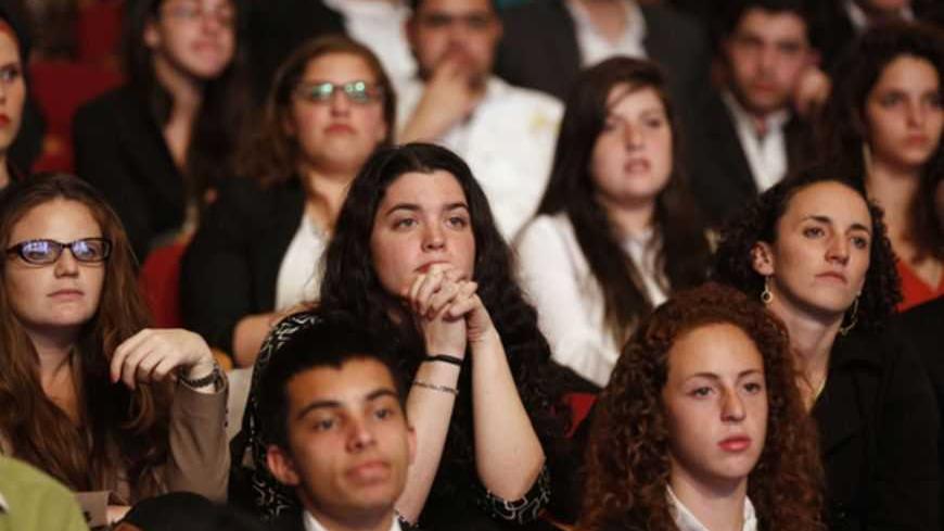 Students listen to U.S. President Barack Obama talk at the Jerusalem Convention Center in Jerusalem, March 21, 2013. President Obama, delivering a keynote speech to Israeli students, said on Thursday that continued settlement activity was "counterproductive" to peace and urged Israelis to accept the Palestinians' right to self-determination.  REUTERS/Larry Downing  (JERUSALEM - Tags: POLITICS EDUCATION) - RTR3F9ZD