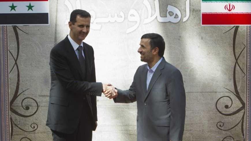 EDITORS' NOTE: Reuters and other foreign media are subject to Iranian restrictions on their ability to report, film or take pictures in Tehran. 

Iranian President Mahmoud Ahmadinejad (R) shakes hands with his Syrian counterpart Bashar al-Assad during an official welcoming ceremony in Tehran October 2, 2010. REUTERS/Morteza Nikoubazl (IRAN - Tags: POLITICS) - RTXSXO5