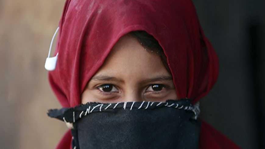A young Bedouin girl is seen near the West Bank city of Jericho August 18, 2008. Threats of evacuation, house demolition, drought, travel restriction, and harassment are just some of the growing hardships the Bedouin community is facing daily, both in Israel and the occupied Palestinian territories. This is all happening in the midst of a painful social transition between traditional and modern values. In Israel and the West Bank, Bedouins are native to the Negev and Judean Deserts which spans across Israel