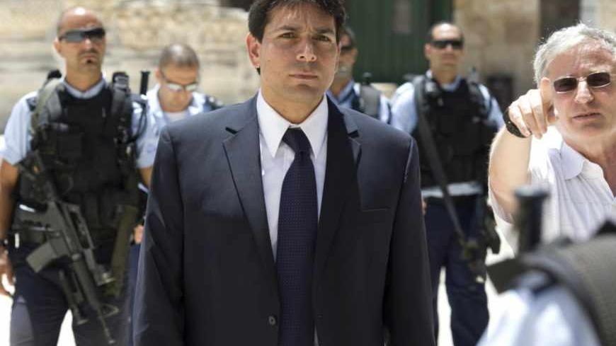 Surrounded by security Deputy Speaker of the Israeli parliament, Danny Danon is taken on a tour of the Temple Mount or Al-Aqsa Mosque Compound the holy site for Judaism and the Islam in Israeli annexed east Jerusalem's old City July 20, 2010, during the 9th of Av day of mourning for the destruction of the First and Second holy temples. AFP PHOTO/AHMAD GHARABLI (Photo credit should read AHMAD GHARABLI/AFP/Getty Images)