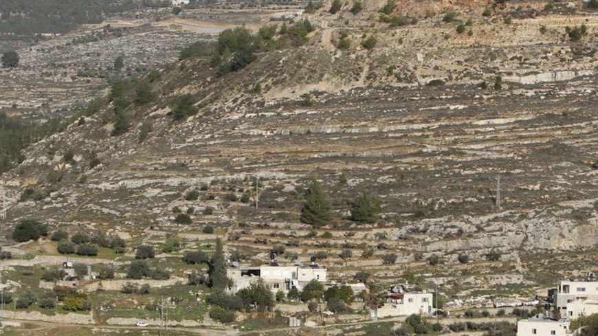 Terraced agricultural fields are seen in Battir village, south of Jerusalem, December 12, 2012. An Israeli government environmental agency challenged the Defence Ministry in court on Wednesday over a section of the controversial West Bank wall that threatens Battir, an ancient Palestinian farming community. Gilo, an urban complex built in a part of the occupied West Bank that Israel captured in a 1967 Middle East war and later annexed to Jerusalem, is seen in the back. REUTERS/Ammar Awad (WEST BANK - Tags: 