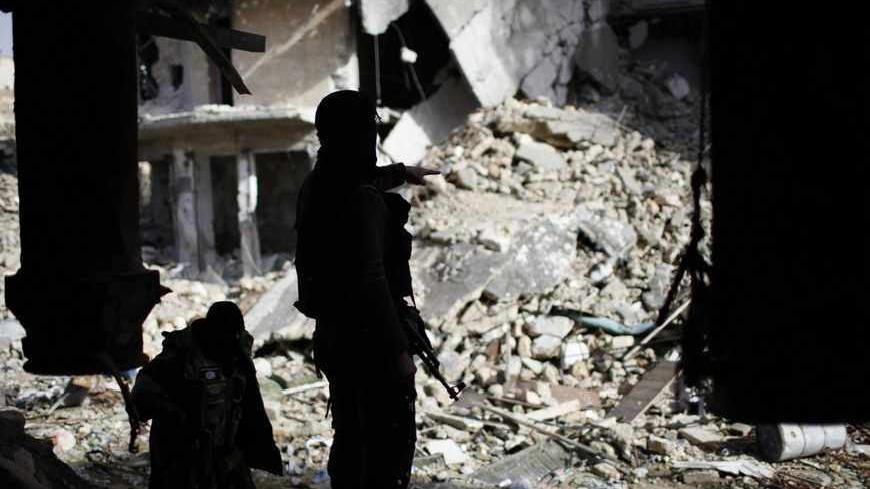 Members of Islamist Syrian rebel group Jabhat al-Nusra take their position on the front line during a fight with Syrian forces loyal to President Bashar al Assad in Aleppo December 24, 2012. Syria special envoy Lakhdar Brahimi discussed solving the country's conflict with President Bashar al-Assad on Monday, but the opposition expressed deepening frustration with the mission following what it called the latest massacre of civilians. REUTERS/Ahmed Jadallah (SYRIA - Tags: CIVIL UNREST POLITICS CONFLICT) - RTR