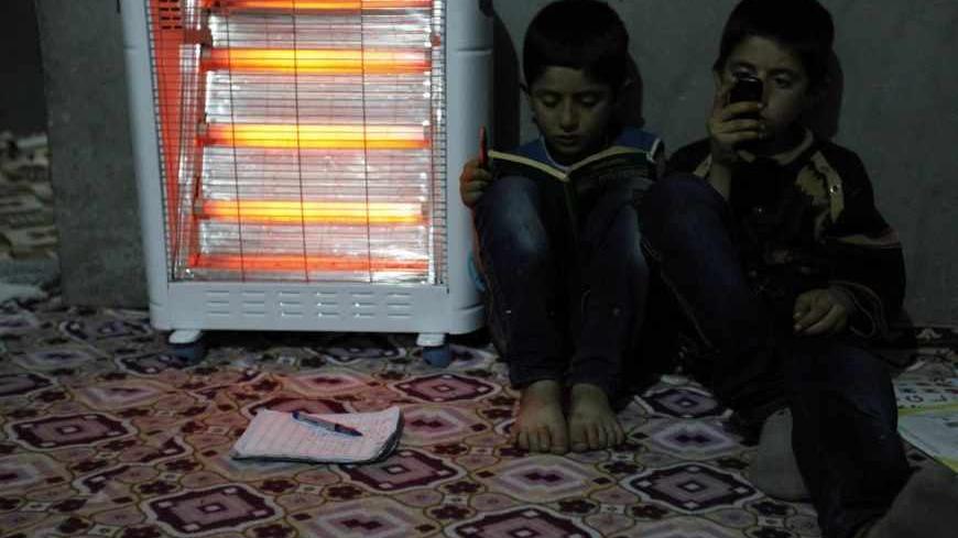 Abdurrahman aged 6 (L) and Osman aged 10 (R) read and chat in their home in Cizre in Sirnak province, near the border with Syria March 23, 2013. Turkey's fledgling peace process with the Kurdistan Workers Party (PKK) militant group is all over the headlines. After three decades of war, 40,000 deaths and a devastating impact on the local economy, everybody seems ready for peace. Pro-Kurdish politicians are focused on boosting minority rights and stronger local government for the Kurds, who make up about 20 p
