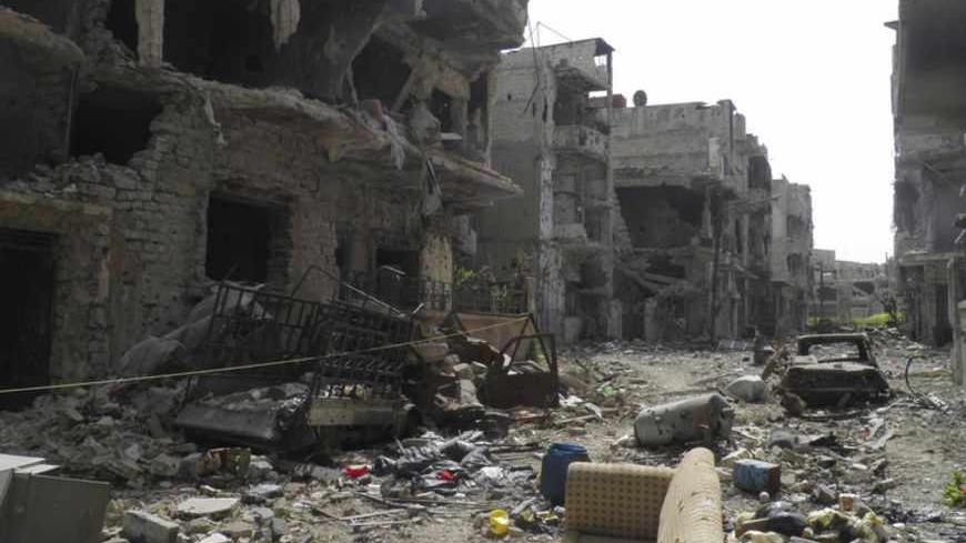 A view shows debris along a street of damaged buildings by what activists said was shelling by forces loyal to Syria's President Bashar al-Assad in Homs April 8, 2013. Picture taken April 8, 2013. REUTERS/Thair al-Khalidi/Shaam News Network/Handout  (SYRIA - Tags: CONFLICT CIVIL UNREST) ATTENTION EDITORS - THIS PICTURE WAS PROVIDED BY A THIRD PARTY. REUTERS IS UNABLE TO INDEPENDENTLY VERIFY THE AUTHENTICITY, CONTENT, LOCATION OR DATE OF THIS IMAGE. FOR EDITORIAL USE ONLY. NOT FOR SALE FOR MARKETING OR ADVER