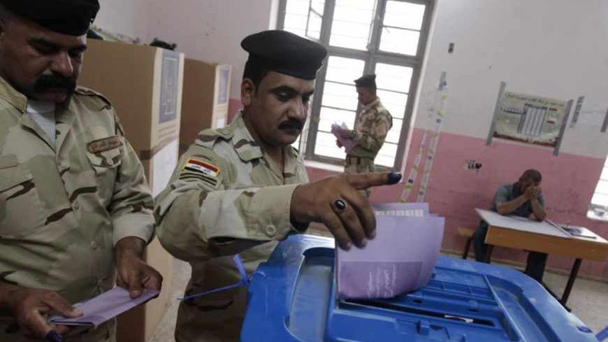 Iraqi soldiers vote at a polling station in Basra, 420 km (261 miles) southeast of Baghdad April 13, 2013. Members of the Iraqi security forces head to polling stations on Saturday in Baghdad and other Iraqi provinces to cast their ballot in the 2013 provincial council election. REUTERS/Atef Hassan  (IRAQ - Tags: ELECTIONS POLITICS) - RTXYK1D