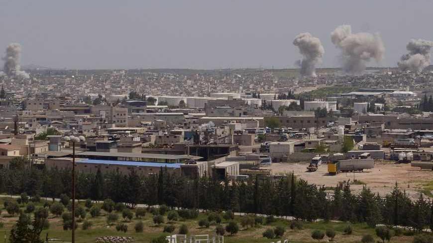 Smoke rises from Sheikh Saeed on the Airport Road near Aleppo city April 13, 2013. Forces loyal to Syria's President Bashar al-Assad began military operations towards Sheikh Saeed to pave the way for their troops to enter. REUTERS/George Ourfalian (SYRIA - Tags: POLITICS CONFLICT) - RTXYKFE