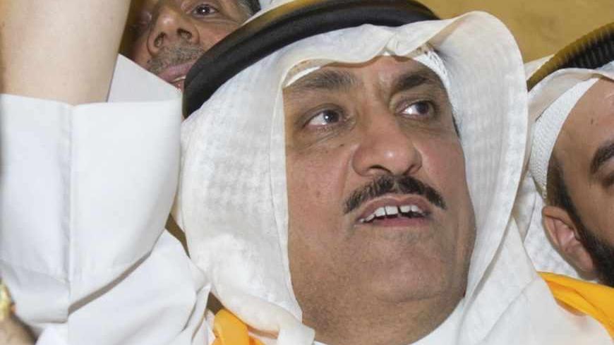 Kuwaiti former member of parliament and opposition politician Musallam al-Barrak (L) greets supporters from his house in Andulos, after a ruling sentenced him to jail for insulting the emir, April 15, 2013. Barrak was sentenced to five years in jail on Monday for insulting the emir, his lawyer said, in a ruling that brought thousands of people to the streets in protest. The Kuwaiti criminal court found Barrak guilty of insulting Sheikh Sabah al-Ahmad al-Sabah in a speech in October last year in which he app