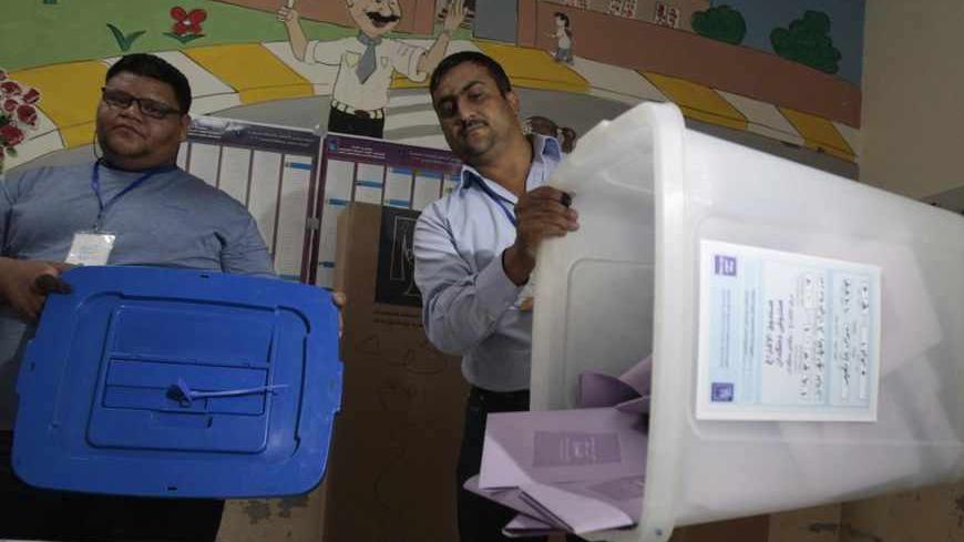 Iraqi election officials empty a ballot box before counting the votes in a constitutional referendum after the closing of a polling station in Basra, 420 km (261 miles) southeast of Baghdad April 20, 2013. Voter participation in Iraq's provincial election on Saturday was 50 percent of eligible voters, the country's electoral authorities said after poll stations closed. Election officials said including results from a special vote a week earlier for members of the armed forces, total participation would be m