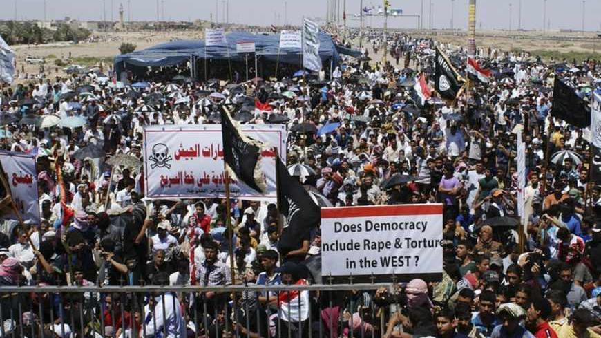 Sunni Muslims take part in an anti-government demonstration in Falluja, 50 km (31 miles) west of Baghdad April 26, 2013. Tens of thousands of Sunni Muslims poured onto the streets of Ramadi and Falluja in the western province of Anbar following Friday prayers, in protest at the perceived marginalisation of their sect since the U.S.-led invasion overthrew Saddam Hussein and empowered majority Shi'ites through the ballot box. REUTERS/Mohanned Faisal (IRAQ - Tags: RELIGION POLITICS CIVIL UNREST) - RTXZ11Y
