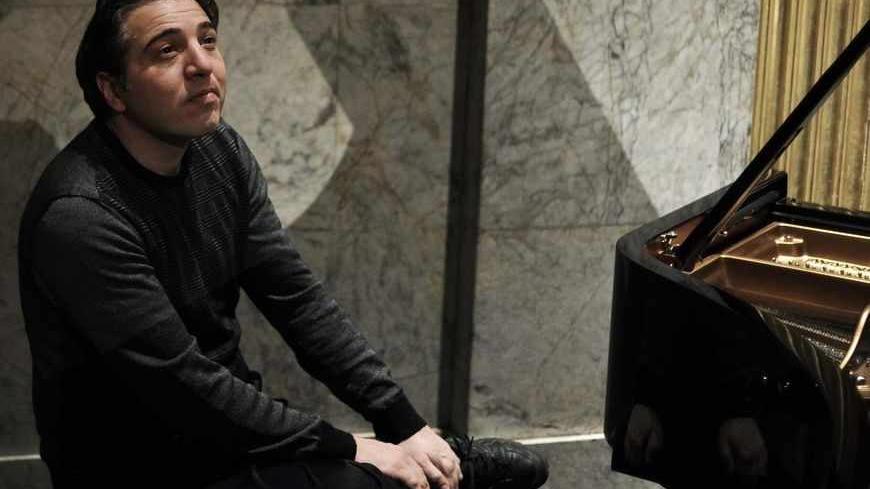 A photo taken on February 9, 2010 shows Turkish pianist and composer Fazil Say posing at the Theatre des Champs-Elysees in Paris. Fazil Say,charged with attacks on religious values for a series of provocative tweets about Islam, will go on trial from October 17, 2012.  Under Turkish law, anyone convicted of insulting religious values can be sentenced to between three months and one year in prison.   AFP PHOTO / FRED DUFOUR        (Photo credit should read FRED DUFOUR/AFP/GettyImages)