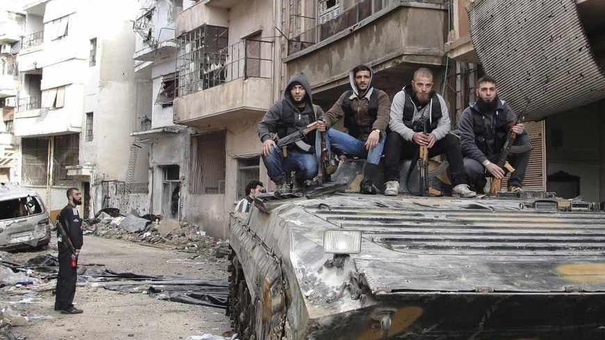 Free Syrian Army fighters pose for a picture on a tank, that they claim to have seized from the Syrian Regime forces, in Homs April 5, 2013 in this picture provided by Shaam News Network. Picture taken April 5, 2013. REUTERS/Mohamed Ibrahim/Shaam News Network/Handout (SYRIA - Tags: POLITICS CIVIL UNREST CONFLICT MILITARY)
ATTENTION EDITORS - THIS PICTURE WAS PROVIDED BY A THIRD PARTY. REUTERS IS UNABLE TO INDEPENDENTLY VERIFY THE AUTHENTICITY, CONTENT, LOCATION OR DATE OF THIS IMAGE. THIS PICTURE IS DISTRI