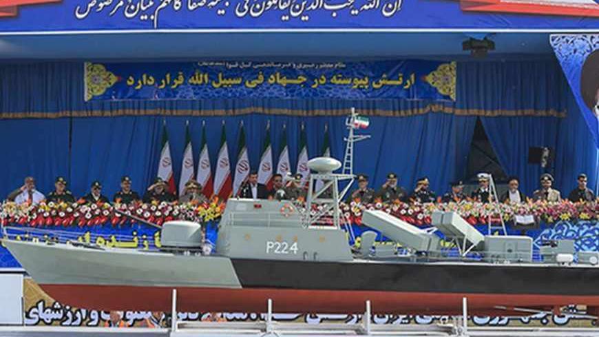 Iranian President Mahmoud Ahmadinejad (C) attends the Army Day parade in Tehran April 18, 2013. REUTERS/Hamid Forootan/ISNA/Handout (IRAN - Tags: MILITARY ANNIVERSARY)
ATTENTION EDITORS - THIS PICTURE WAS PROVIDED BY A THIRD PARTY. REUTERS IS UNABLE TO INDEPENDENTLY VERIFY THE AUTHENTICITY, CONTENT, LOCATION OR DATE OF THIS IMAGE. THIS PICTURE IS DISTRIBUTED EXACTLY AS RECEIVED BY REUTERS, AS A SERVICE TO CLIENTS. FOR EDITORIAL USE ONLY. NOT FOR SALE FOR MARKETING OR ADVERTISING CAMPAIGNS - RTXYQLB