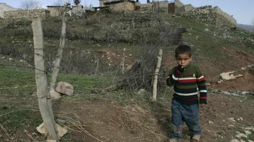 A Kurdish boy walks in the village of Sheladiz near the Iraqi-Turkish borders February 27, 2008. Picture taken February 27, 2008.    REUTERS/Ceerwan Aziz   (IRAQ) - RTR1XP6H