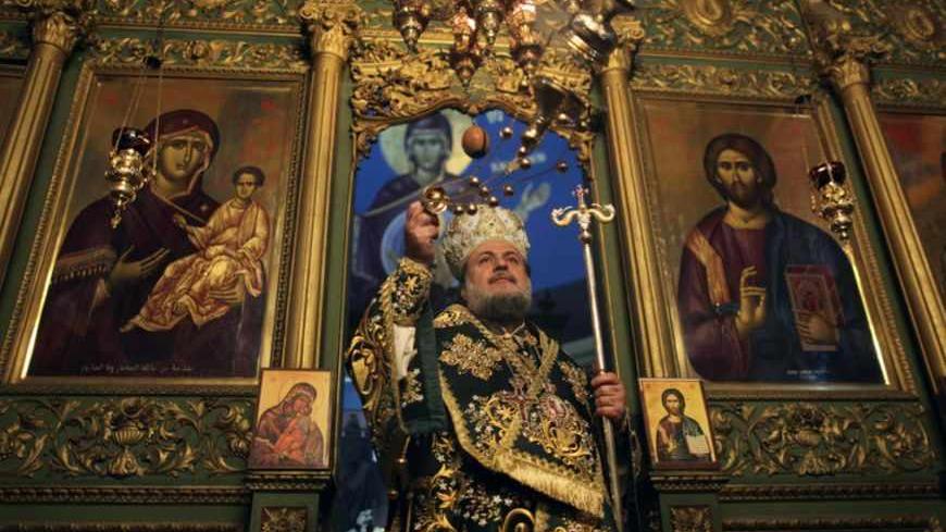 A Greek Orthodox priest attends Christmas services at the Saint Porfirios church in Gaza City January 7, 2012. REUTERS/Mohammed Salem (GAZA - Tags: RELIGION) - RTR2VZBO