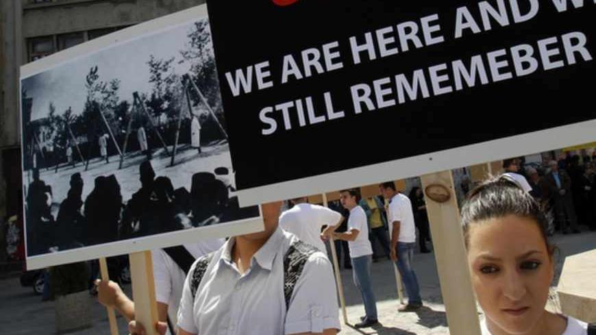 Members of Armenian community in Romania hold banners during a rally marking the anniversary of mass killings of Armenians in Ottoman Empire in 1915, in downtown Bucharest April 24, 2012. Armenia, backed by many historians and parliaments, says that about 1.5 million Christian Armenians were killed in what is now eastern Turkey during World War One in a deliberate policy of genocide ordered by the Ottoman government. Successive Turkish governments and the vast majority of Turks feel that the charge of genoc