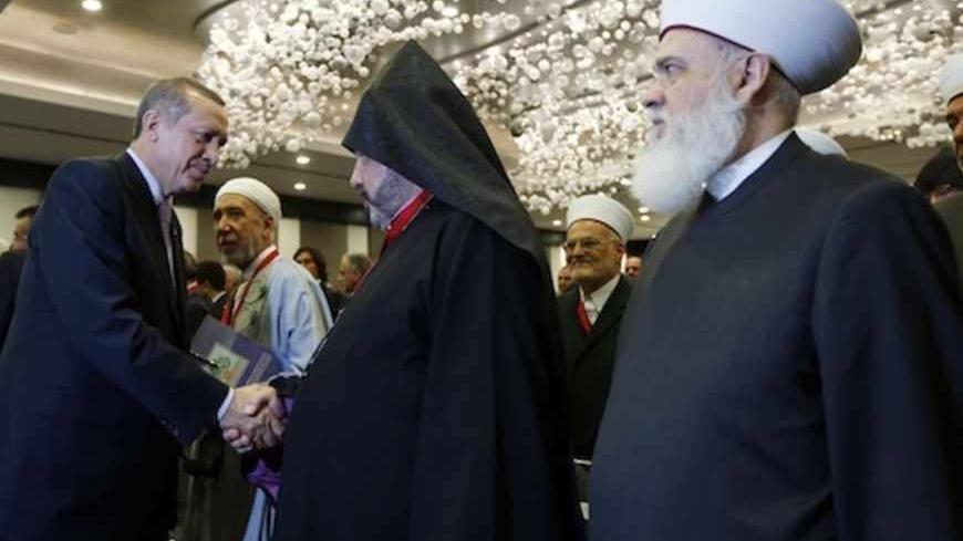 Turkey's Prime Minister Tayyip Erdogan (L) shakes hands with Archbishop Nourhan Manougian, Patriarchal Vicar of the Armenian Patriarchate of Jerusalem, during an international conference on the Arab awakening and peace in the Middle East in Istanbul September 7, 2012. REUTERS/Murad Sezer (TURKEY  - Tags: POLITICS RELIGION) - RTR37O19