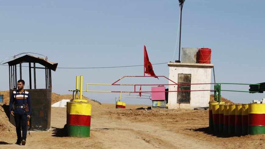 An officer of the Syrian Kurdish Democratic Union Party (PYD) stands guard near the Syrian-Iraq border October 31, 2012. Iraqi Kurdish President Masoud Barzani warned Kurds in Syria against being sucked into the "fires of discord," urging them to preserve Kurdish unity as tensions between rival factions threaten to spillover into violence. Syria's Kurds see the war ravaging their country as an unprecedented opportunity to gain the kind of freedoms enjoyed by their ethnic kin in neighbouring Iraq, where they