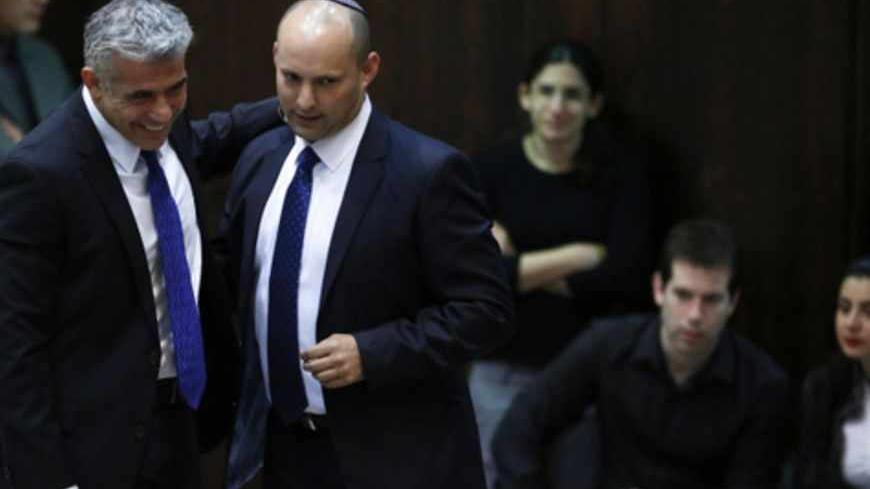 Israel's Finance Minister Yair Lapid (L) and Minister of Economics and Trade Naftali Bennett (2nd L) walk together during the swearing-in ceremony, at the Knesset, the Israeli Parliament, in Jerusalem March 18, 2013. Israeli Prime Minister Benjamin Netanyahu's new governing coalition took office after a parliamentary vote on Monday with powerful roles reserved for supporters of settlers in occupied territory. REUTERS/Baz Ratner (JERUSALEM - Tags: POLITICS) - RTR3F5XP