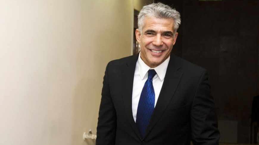 Israel's Finance Minister Yair Lapid arrives to the first cabinet meeting of the 33rd Israeli government, in Jerusalem March 18, 2013. Israeli Prime Minister Benjamin Netanyahu's new governing coalition took office after a parliamentary vote on Monday with powerful roles reserved for supporters of settlers in occupied territory. REUTERS/David Vaaknin/Pool (JERUSALEM - Tags: POLITICS) - RTR3F60Q