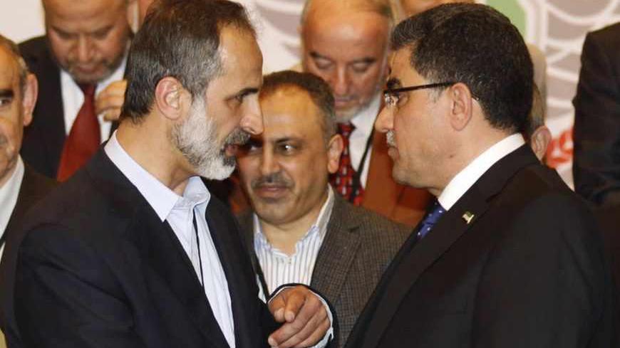 Syria's provisional prime minister Ghasssan Hitto (R) talks to Syrian National Coalition (SNC) President Mouaz al-Khatib after a news conference in Istanbul March 19, 2013. Syrian opposition leaders chose Western-educated technocrat Hitto as provisional prime minister in what they hope will be the first step to fill a power vacuum arising from a two-year-long revolt against President Bashar al-Assad. REUTERS/Osman Orsal (TURKEY - Tags: POLITICS CONFLICT CIVIL UNREST) - RTR3F6U4