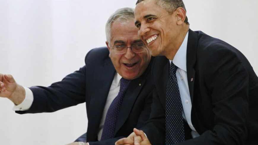 U.S. President Barack Obama (R) watches a cultural event alongside Palestinian Prime Minister Salam Fayyad at the Al Bireh Youth Center in Ramallah March 21, 2013. REUTERS/Jason Reed (WEST BANK - Tags: POLITICS) - RTR3F9QE
