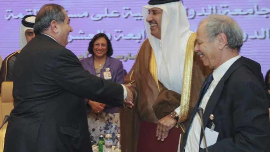 Iraq's Foreign Minister Hoshiyar Zebari (L) shakes hands with Qatari Foreign Minister Sheikh Hamed bin Jassem Jaber al-Thani (C) during preparatory meeting with Arab foreign ministers ahead of the annual Arab League Summit in Doha March 24, 2013. REUTERS/Stringer (QATAR - Tags: POLITICS) - RTXXVRM