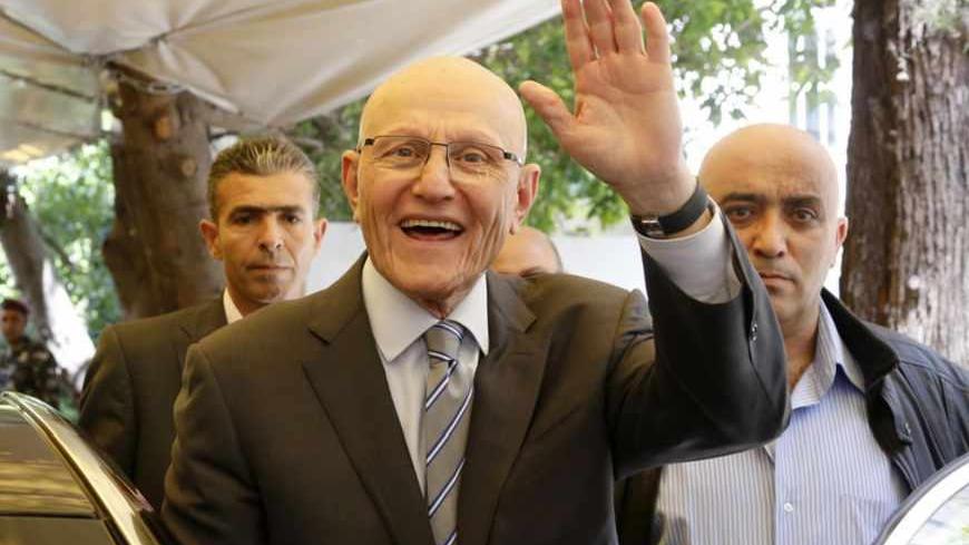 Lebanese former minister Tammam Salam gestures to his supporters in front of his house while going to the presidential palace in Baabda, Beirut April 6, 2013. Shi'ite militant group Hezbollah, its allies and pro-Western rivals on Friday backed Sunni politician Tammam Salam to be Lebanon's new prime minister, handing him an overwhelming parliamentary endorsement to form a government. REUTERS/Mohamed Azakir (LEBANON - Tags: POLITICS) - RTXYAJC