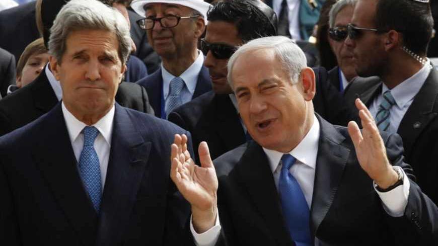 Israeli Prime Minister Benjamin Netanyahu (C) speaks with US Secretary of State John Kerry as President Shimon Peres (R) sits beside them during a ceremony marking Israel's annual day of Holocaust remembrance, at Yad Vashem in Jerusalem April 8, 2013. Israel on Monday commemorates the six million Jews killed by the Nazis in the Holocaust during World War Two. 
REUTERS/Gali Tibbon/Pool (JERUSALEM - Tags: POLITICS ANNIVERSARY CONFLICT TPX IMAGES OF THE DAY) - RTXYDCL