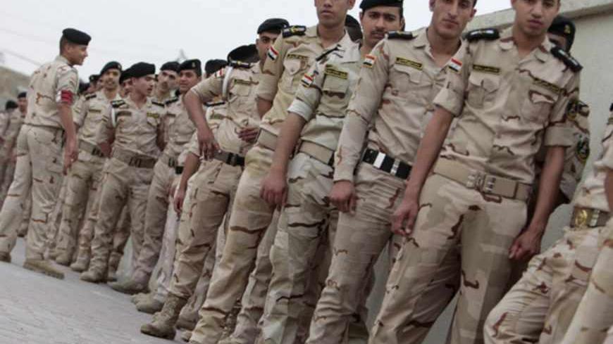 Iraqi security forces wait in line to vote, outside a polling station in Basra, 420 km (261 miles) southeast of Baghdad April 13, 2013. Members of the Iraqi security forces head to polling stations on Saturday in Baghdad and other Iraqi provinces to cast their ballot in the 2013 provincial council election. REUTERS/Atef Hassan (IRAQ - Tags: ELECTIONS POLITICS MILITARY) - RTXYK1F