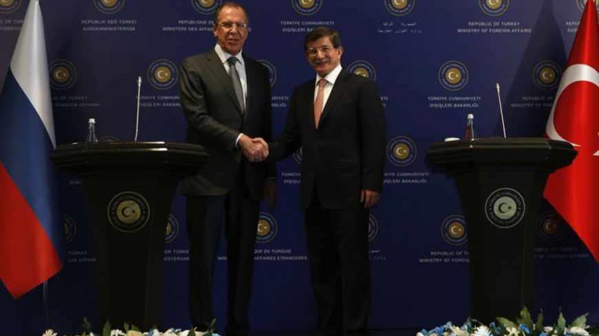 Russia's Foreign Minister Sergei Lavrov and his Turkish counterpart Ahmet Davutoglu (R) shake hands following a joint news conference at Ciragan Palace in Istanbul April 17, 2013. REUTERS/Murad Sezer (TURKEY - Tags: POLITICS) - RTXYOXV