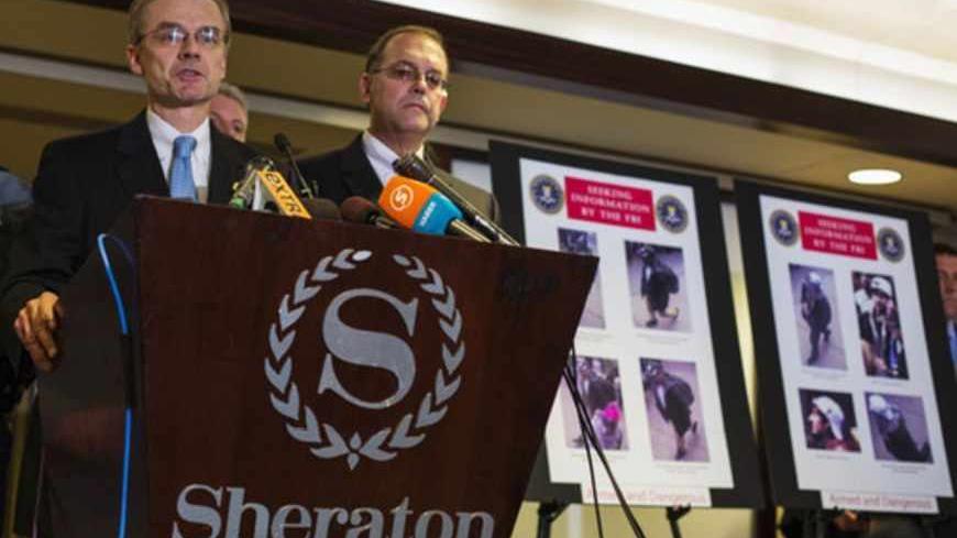 Special Agent in Charge of the FBI's Boston Field Office Richard DesLauriers (L) speaks as he releases images of suspects in the two explosions during the Boston Marathon, at a news conference in Boston, Massachusetts, April 18, 2013. The FBI said on Thursday that it has identified two suspects in the Boston Marathon bombing and is asking the public for help in identifying the two men. REUTERS/Lucas Jackson (UNITED STATES - Tags: SPORT ATHLETICS CIVIL UNREST CRIME LAW) - RTXYRAS