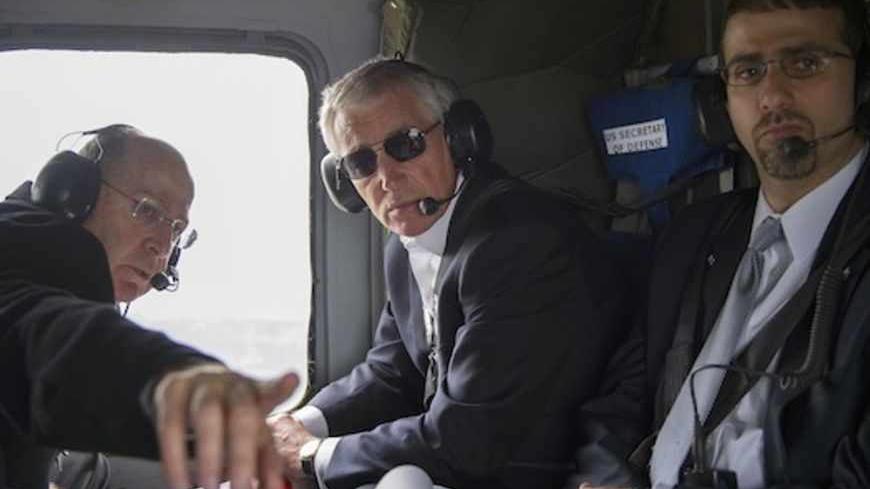U.S. Defense Secretary Chuck Hagel (R) and his Israeli counterpart Moshe Yaalon (L) look out of the window during a helicopter tour of the Israeli-annexed Golan Heights April 22, 2013. Israel suggested on Monday it would be patient before taking any military action against Iran's nuclear programme, saying during a visit by Hagel there was still time for other options. REUTERS/Jim Watson/Pool (ISRAEL - Tags: POLITICS MILITARY TRAVEL) - RTXYVU8